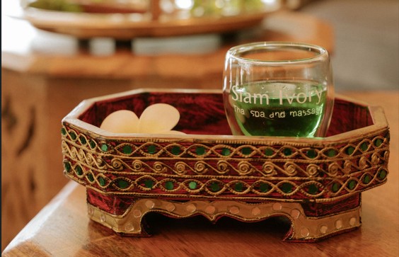 Siam Ivory signature green welcome drink served in a decorative Thai tray